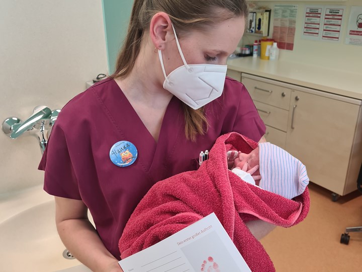Hebamme Hanna mit einem Neugeborenen